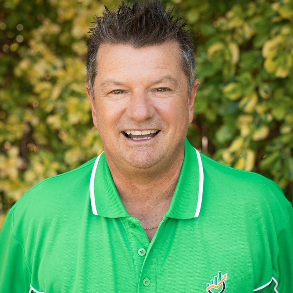 Jerry Gibb, Mobile Mortgage Broker wearing Green shirt against the background of a tree